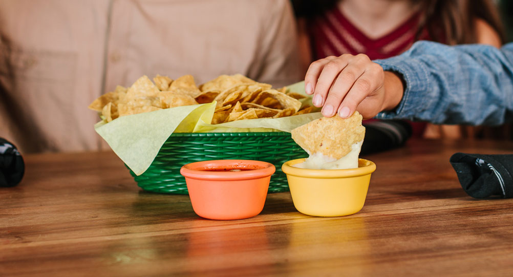 Fresh tortilla chips and famous creamy jalapeño white sauce at Miguel’s Cocina